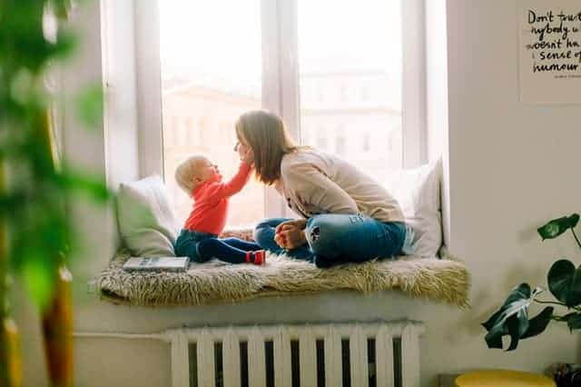 Baby touching mom's face