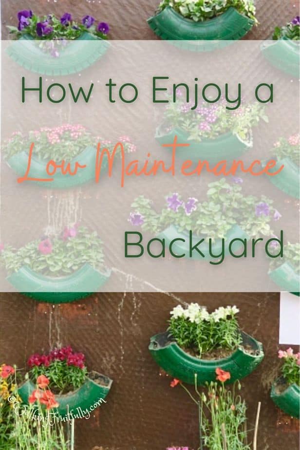 green painted tires cut and used as planters with flowers hanging on a brown wall