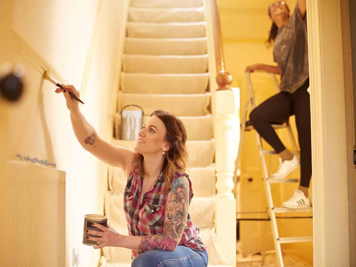 Family touching up paint in entryway