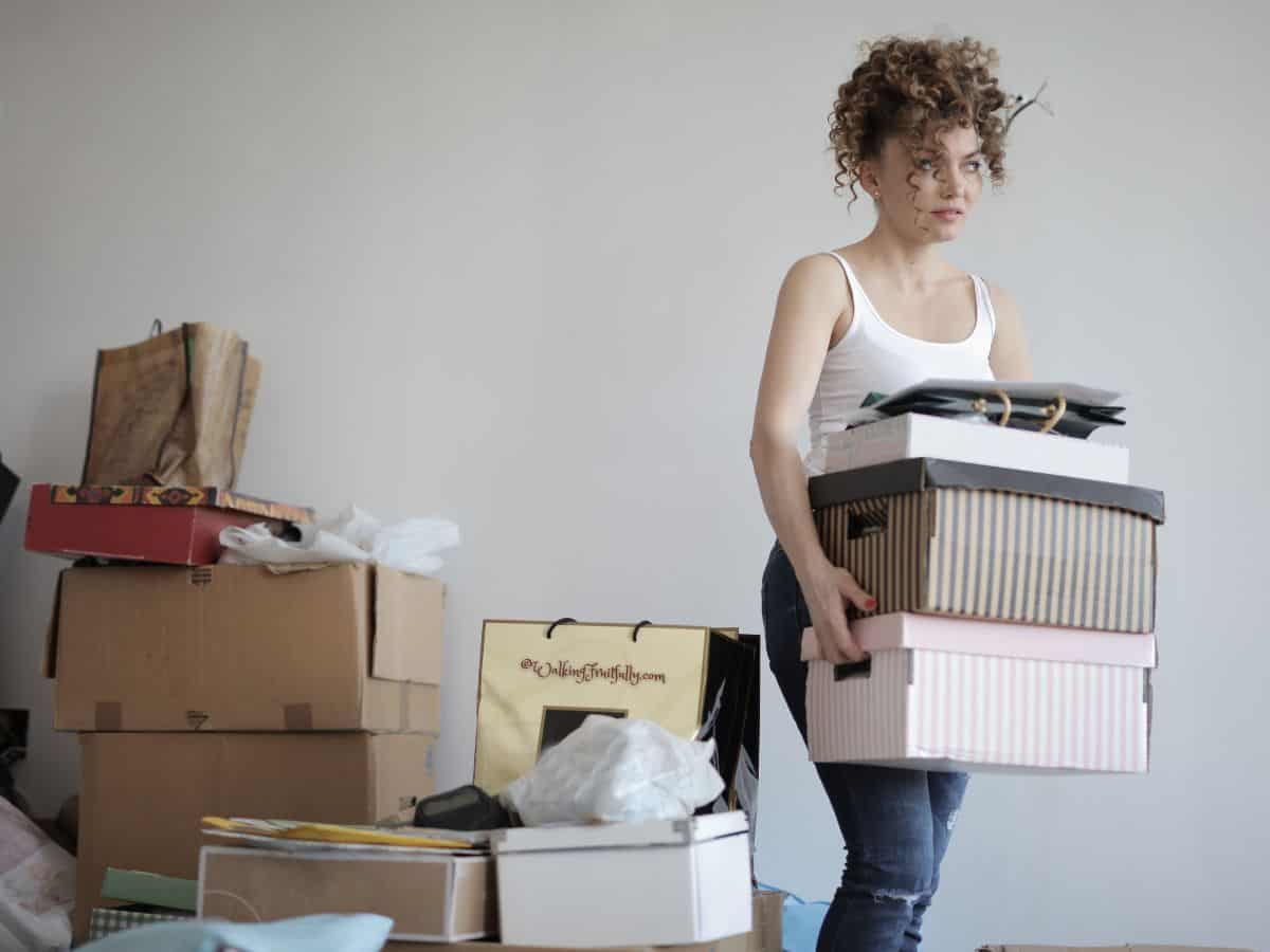 Woman carrying boxes in home