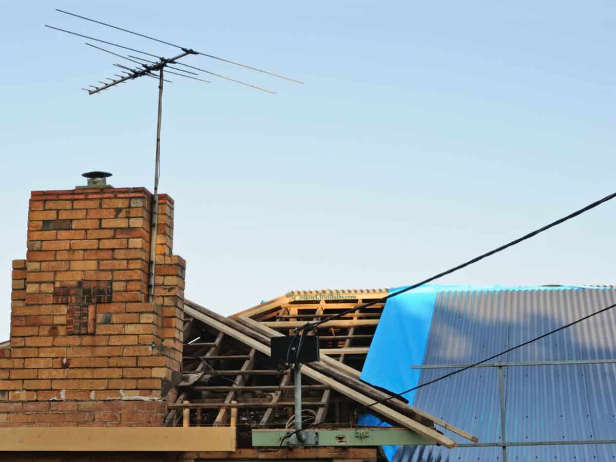 Roof of home in various stages of repair