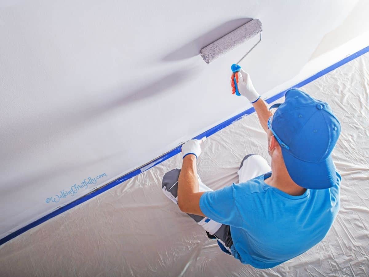 Man painting an interior wall