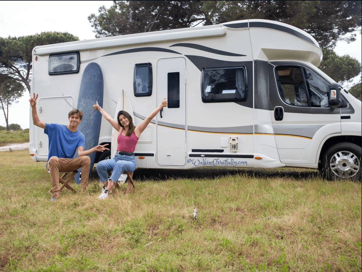 Younger couple sitting outside their RV